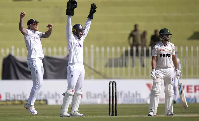 England's Ben Stokes, left, and Jamie Smith, center, appeal successful LWB out Pakistan's Salman Ali Agha, right, during the day two of third test cricket match between Pakistan and England, in Rawalpindi, Pakistan, Friday, Oct. 25, 2024. (AP Photo/Anjum Naveed)