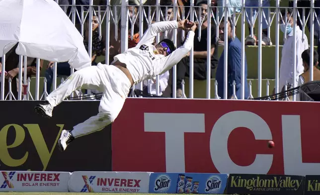 Pakistan's Saim Ayub jumps to take a catch of England's Jamie Smith on the boundary edge during the day one of third test cricket match between Pakistan and England, in Rawalpindi, Pakistan, Thursday, Oct. 24, 2024. (AP Photo/Anjum Naveed)