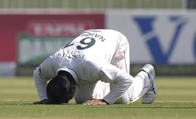 Pakistan's Noman Ali performs Sajdah, a prayer bow in gratitude to God, after taking his fifth wicket during the day three of third test cricket match between Pakistan and England, in Rawalpindi, Pakistan, Saturday, Oct. 26, 2024. (AP Photo/Anjum Naveed)