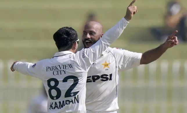 Pakistan's Sajid Khan, right, celebrates with teammates after taking the wicket of England's Gus Atkinson during the day three of third test cricket match between Pakistan and England, in Rawalpindi, Pakistan, Saturday, Oct. 26, 2024. (AP Photo/Anjum Naveed)