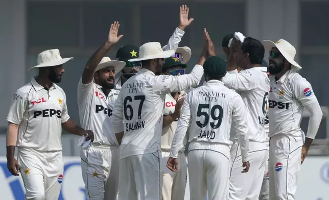 Pakistan's Noman Ali, second right, celebrates with teammates after taking the wicket of England's Joe Root, second right, during the fourth day of the second test cricket match between Pakistan and England, in Multan, Pakistan, Friday, Oct. 18, 2024. (AP Photo/K.M. Chaudary)