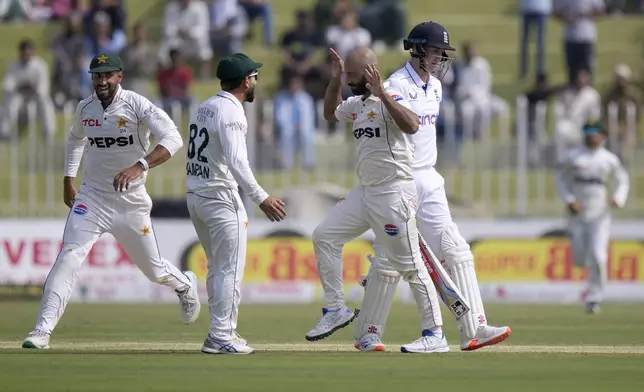 Pakistan's Sajid Khan, second right, celebrates after taking the wicket of England's Harry Brook, right, during the day one of third test cricket match between Pakistan and England, in Rawalpindi, Pakistan, Thursday, Oct. 24, 2024. (AP Photo/Anjum Naveed)