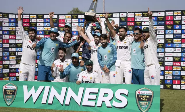 Pakistani players pose for group photo with the trophy after winning the series against England by 2-1, in Rawalpindi, Pakistan, Saturday, Oct. 26, 2024. (AP Photo/Anjum Naveed)