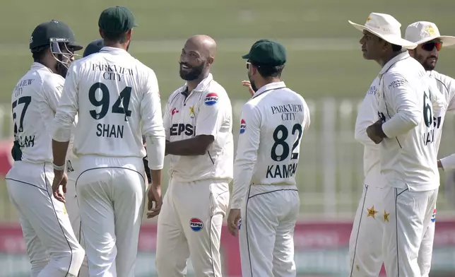 Pakistan's Sajid Khan, center, celebrates with teammates after taking the wicket of England's Jamie Smith during the day three of third test cricket match between Pakistan and England, in Rawalpindi, Pakistan, Saturday, Oct. 26, 2024. (AP Photo/Anjum Naveed)