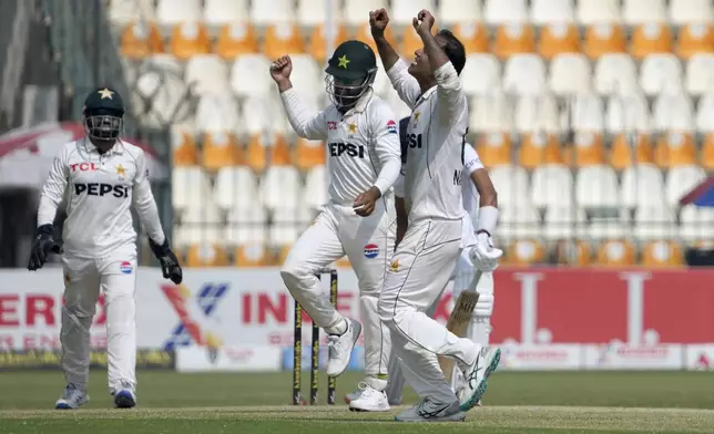 Pakistan's Noman Ali, right, and teammates celebrates after winning the second test cricket match against England, in Multan, Pakistan, Friday, Oct. 18, 2024. (AP Photo/K.M. Chaudary)