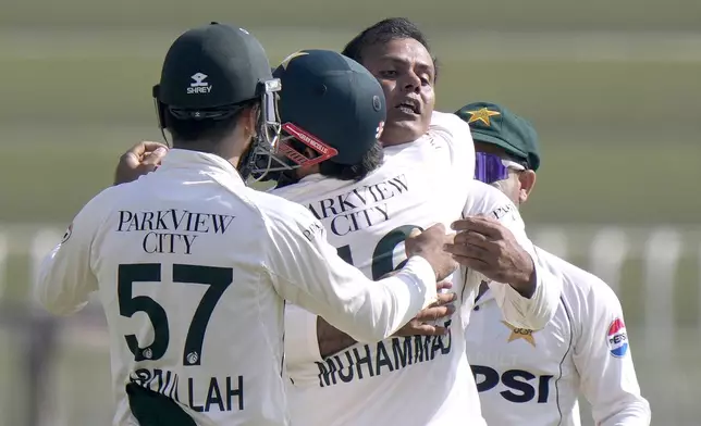 Pakistan's Noman Ali, center, celebrates with teammates after taking the wicket of England's Harry Brook during the day three of third test cricket match between Pakistan and England, in Rawalpindi, Pakistan, Saturday, Oct. 26, 2024. (AP Photo/Anjum Naveed)