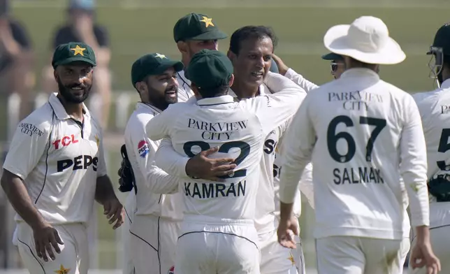 Pakistan's Noman Ali, center, celebrates with teammates after taking the wicket of England's Joe Root during the day three of third test cricket match between Pakistan and England, in Rawalpindi, Pakistan, Saturday, Oct. 26, 2024. (AP Photo/Anjum Naveed)