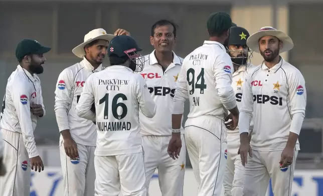 Pakistan's Noman Ali, centre, celebrates with teammates after taking the wicket of England's Ben Stokes during the second day of the second test cricket match between Pakistan and England, in Multan, Pakistan, Wednesday, Oct. 16, 2024. (AP Photo/K.M. Chaudary)