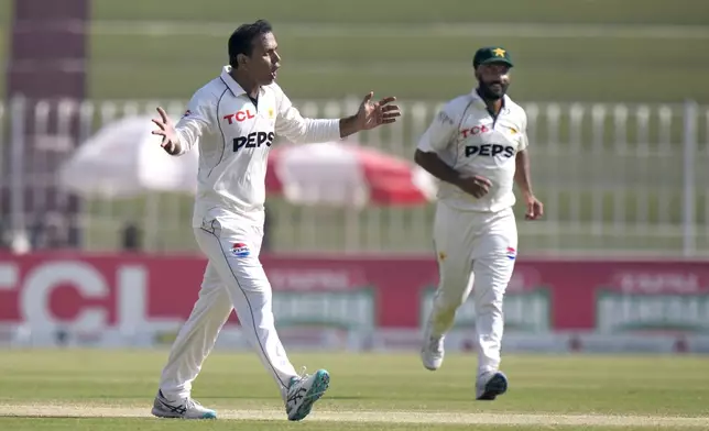 Pakistan's Noman Ali, left, celebrates after taking the wicket of England's Ben Stokes during the day three of third test cricket match between Pakistan and England, in Rawalpindi, Pakistan, Saturday, Oct. 26, 2024. (AP Photo/Anjum Naveed)