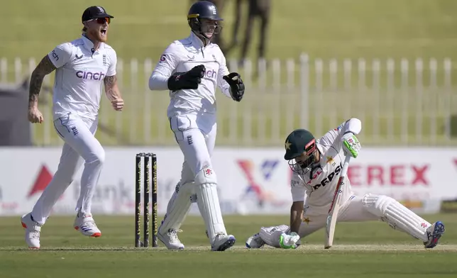 England's Ben Stokes, left, and Jamie Smith, center, celebrate the dismissal of Pakistan's Mohammad Rizwan, right, during the day two of third test cricket match between Pakistan and England, in Rawalpindi, Pakistan, Friday, Oct. 25, 2024. (AP Photo/Anjum Naveed)