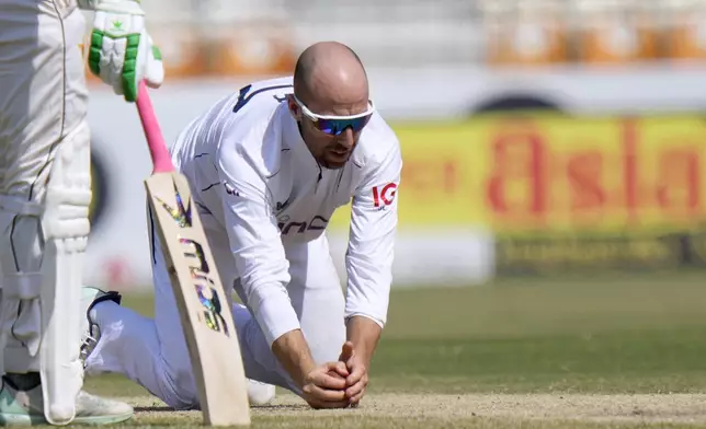 England's Jack Leach takes the catch of Pakistan's Shaheen Shah Afridi during the fifth day of the first test cricket match between Pakistan and England, in Multan, Pakistan, Friday, Oct. 11, 2024. (AP Photo/Anjum Naveed)