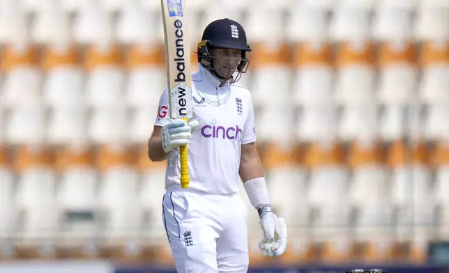 England's Joe Root celebrates after scoring fifty during the third day of the first test cricket match between Pakistan and England, in Multan, Pakistan, Wednesday, Oct. 9, 2024. (AP Photo/Anjum Naveed)