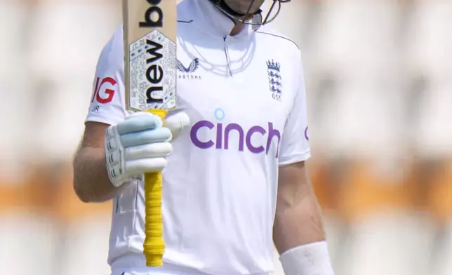 England's Joe Root celebrates after scoring fifty during the third day of the first test cricket match between Pakistan and England, in Multan, Pakistan, Wednesday, Oct. 9, 2024. (AP Photo/Anjum Naveed)