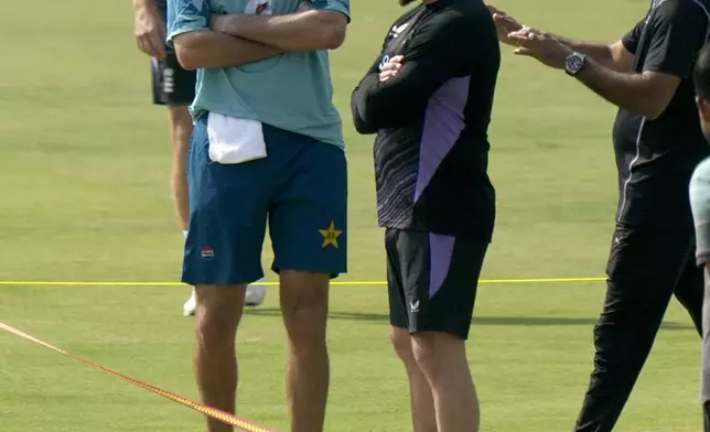 Pakistan's test team's head coach Jason Gillespie, left, chats with England's coach Brendon McCullum, second right before a practice session, in Multan, Pakistan, Sunday, Oct. 6, 2024. (AP Photo/Anjum Naveed)