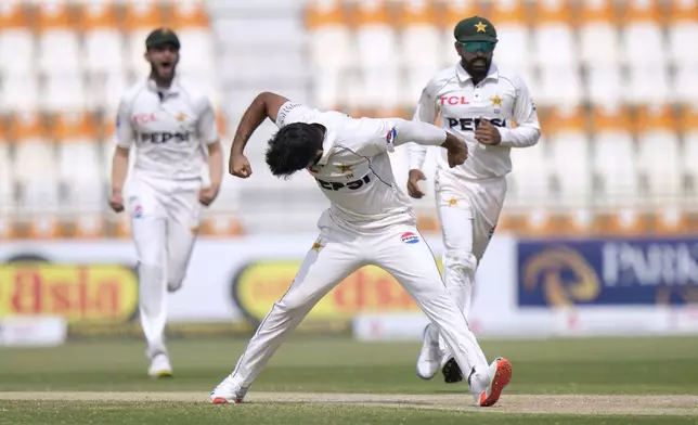 Pakistan's Aamer Jamal, center, celebrates after taking the wicket of England's Ben Duckett during the third day of the first test cricket match between Pakistan and England, in Multan, Pakistan, Wednesday, Oct. 9, 2024. (AP Photo/Anjum Naveed)