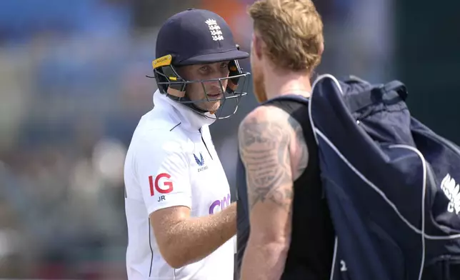 England's Joe Root, left, who is now England's leading test run-scorer. is congratulated by Ben Stokes as he walks off the field on the lunch break during the third day of the first test cricket match between Pakistan and England, in Multan, Pakistan, Wednesday, Oct. 9, 2024. (AP Photo/Anjum Naveed)