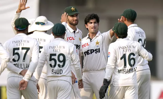 Pakistan's Naseem Shah, third right, celebrates with teammates after taking the wicket of England's Ollie Pope during the second day of the first test cricket match between Pakistan and England, in Multan, Pakistan, Tuesday, Oct. 8, 2024. (AP Photo/Anjum Naveed)