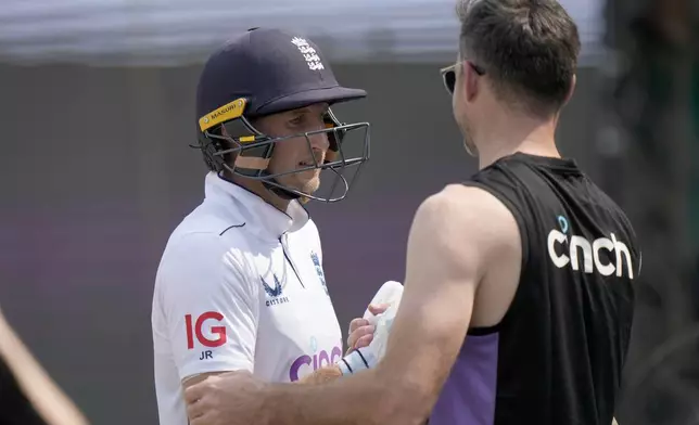 England's Joe Root, left, who is now England's leading test run-scorer. is congratulated by James Anderson as he walks off the field on the lunch break during the third day of the first test cricket match between Pakistan and England, in Multan, Pakistan, Wednesday, Oct. 9, 2024. (AP Photo/Anjum Naveed)