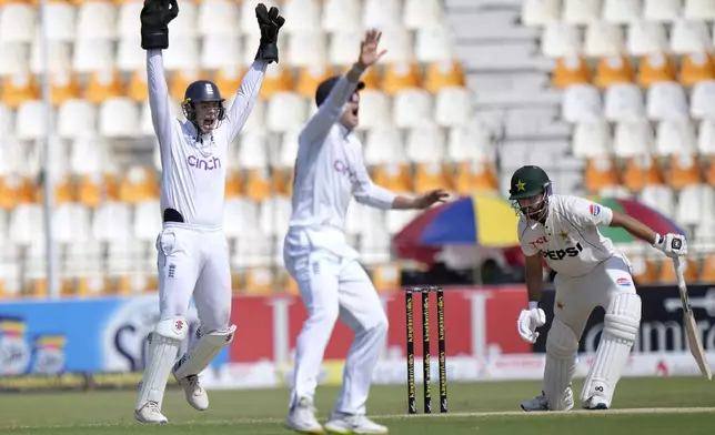 England's Jamie Smith, left, and Ollie Pope, center, appeal for LBW out of Pakistan's Salman Ali Agha during the fifth day of the first test cricket match between Pakistan and England, in Multan, Pakistan, Friday, Oct. 11, 2024. (AP Photo/Anjum Naveed)