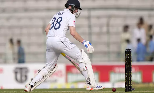 England's Harry Brook attempts to stop the ball during the third day of the first test cricket match between Pakistan and England, in Multan, Pakistan, Wednesday, Oct. 9, 2024. (AP Photo/Anjum Naveed)