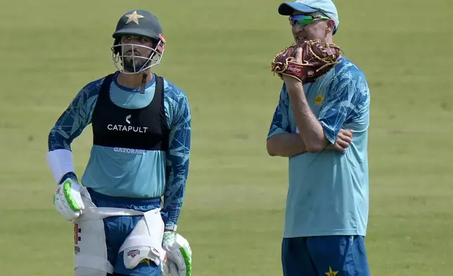 Pakistan's test team skipper Shah Masood, left, chats with test team's head coach Jason Gillespie during a practice session, in Multan, Pakistan, Saturday, Oct. 5, 2024. (AP Photo/Anjum Naveed)