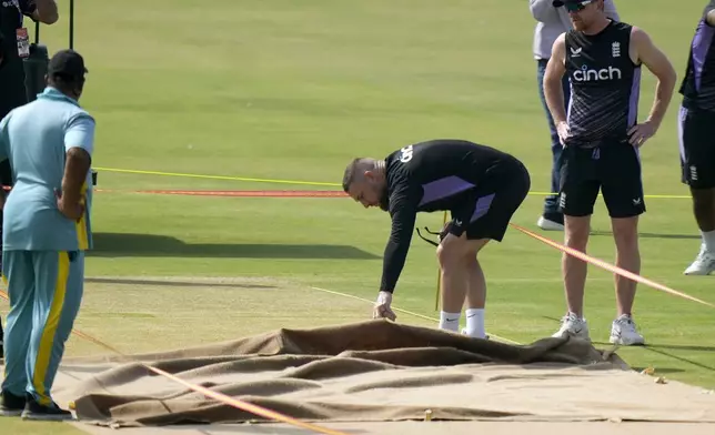 England's coach Brendon McCullum, second right, examines the pitch preparing for 1st test cricket match between England and Pakistan, before a practice session, in Multan, Pakistan, Sunday, Oct. 6, 2024. (AP Photo/Anjum Naveed)