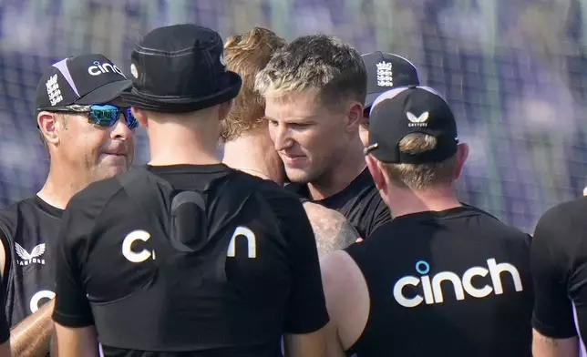 England's Brydon Carse, center, hugs with Ben Stokes after receiving test debut before the start of the play of first test cricket match between Pakistan and England, in Multan, Pakistan, Monday, Oct. 7, 2024. (AP Photo/Anjum Naveed)