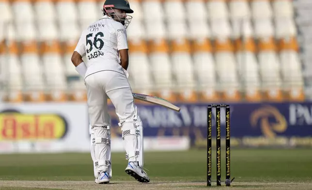 Pakistan's Babar Azam looks back after his dismissal during the fourth day of the first test cricket match between Pakistan and England, in Multan, Pakistan, Thursday, Oct. 10, 2024. (AP Photo/Anjum Naveed)