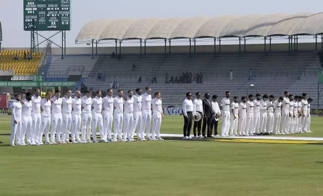 Players of England, left, and Pakistan stand for their national anthem before the start of the play of first test cricket match between Pakistan and England, in Multan, Pakistan, Monday, Oct. 7, 2024. (AP Photo/Anjum Naveed)