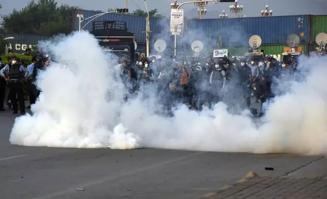 Police officers fire tear gas to disperse the supporters of imprisoned former Prime Minister Imran Khan's party Pakistan Tehreek-e-Insaf during a protest in Islamabad, Pakistan, Friday, Oct. 4, 2024.(AP Photo/W.K. Yousafzai)