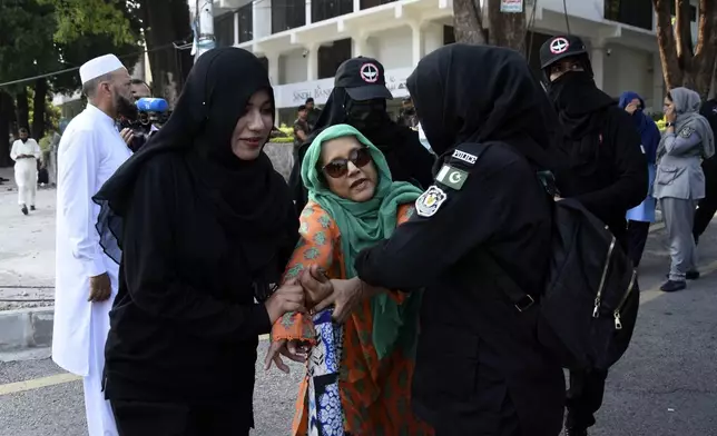 Security personnel detain supporters of imprisoned former Prime Minister Imran Khan's party Pakistan Tehreek-e-Insaf during a protest in Islamabad, Pakistan, Friday, Oct. 4, 2024.(AP Photo/W.K. Yousafzai)