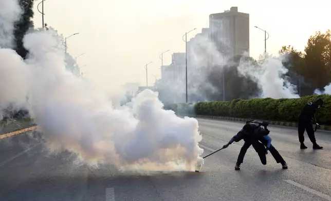 Police officers fire tear gas to disperse the supporters of imprisoned former Prime Minister Imran Khan's party Pakistan Tehreek-e-Insaf during a protest in Islamabad, Pakistan, Friday, Oct. 4, 2024.(AP Photo/W.K. Yousafzai)