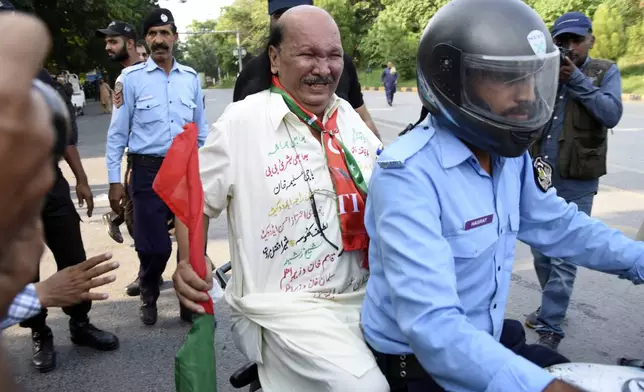 Security personnel detain supporters of imprisoned former Prime Minister Imran Khan's party Pakistan Tehreek-e-Insaf during a protest in Islamabad, Pakistan, Friday, Oct. 4, 2024.(AP Photo/W.K. Yousafzai)