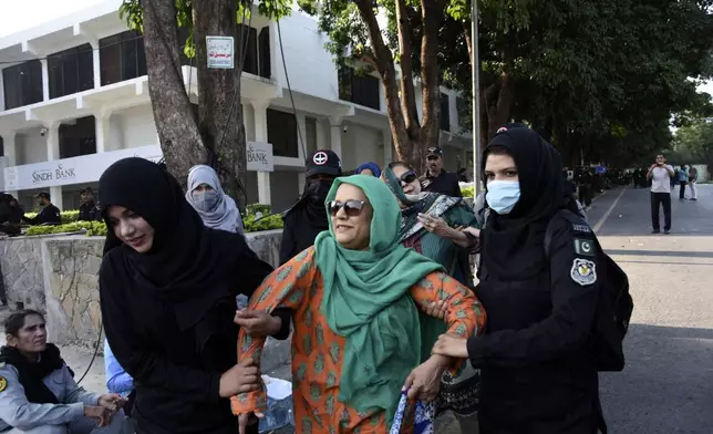 Security personnel detain supporters of imprisoned former Prime Minister Imran Khan's party Pakistan Tehreek-e-Insaf during a protest in Islamabad, Pakistan, Friday, Oct. 4, 2024. (AP Photo/W.K. Yousafzai)