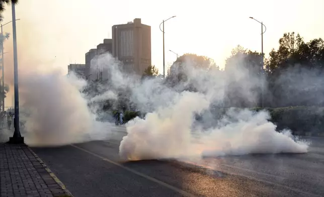 Police officers fire tear gas to disperse the supporters of imprisoned former Prime Minister Imran Khan's party Pakistan Tehreek-e-Insaf during a protest in Islamabad, Pakistan, Friday, Oct. 4, 2024. (AP Photo/W.K. Yousafzai)