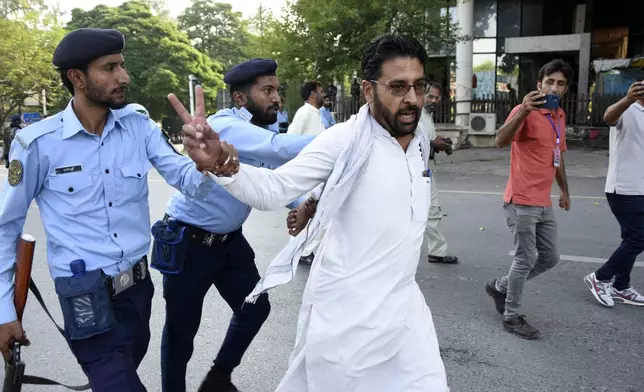 Security personnel detain supporters of imprisoned former Prime Minister Imran Khan's party Pakistan Tehreek-e-Insaf during a protest in Islamabad, Pakistan, Friday, Oct. 4, 2024.(AP Photo/W.K. Yousafzai)