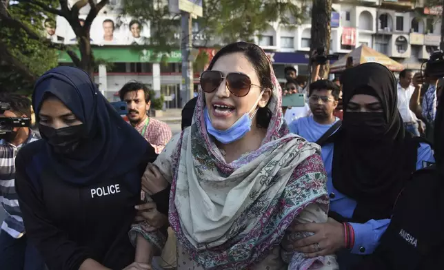 Security personnel detain supporters of imprisoned former Prime Minister Imran Khan's party Pakistan Tehreek-e-Insaf during a protest in Islamabad, Pakistan, Friday, Oct. 4, 2024.(AP Photo/W.K. Yousafzai)