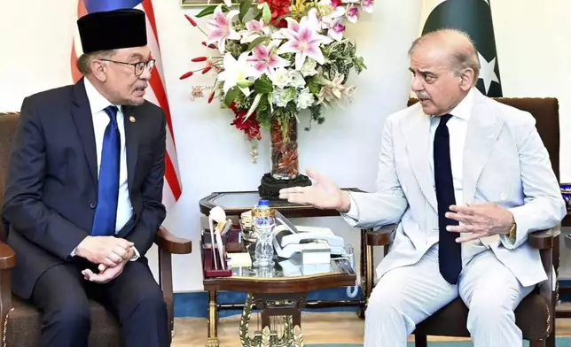 In this photo released by Pakistan's Prime Minister Office, Pakistan's Prime Minister Shehbaz Sharif, right, meets with Malaysian Prime Minister Anwar Ibrahim, in Islamabad, Pakistan, Thursday, Oct. 3, 2024. (Prime Minister Office via AP)