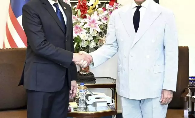 In this photo released by Pakistan's Prime Minister Office, Pakistan's Prime Minister Shehbaz Sharif, right, and Malaysian Prime Minister Anwar Ibrahim, shake hands as they pose for photos during their meeting in Islamabad, Pakistan, Thursday, Oct. 3, 2024. (Prime Minister Office via AP)