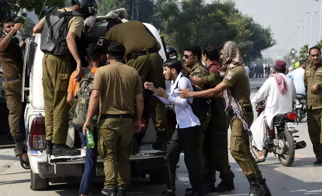 Police officers detain students following a students protest over an alleged on-campus rape in Punjab, in Rawalpindi, Pakistan, Thursday, Oct. 17, 2024. (AP Photo/W.K. Yousafzai)