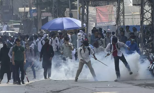 Police fire tear gas to disperse students protesting over an alleged on-campus rape in Punjab, in Rawalpindi, Pakistan, Thursday, Oct. 17, 2024. (AP Photo/W.K. Yousafzai).