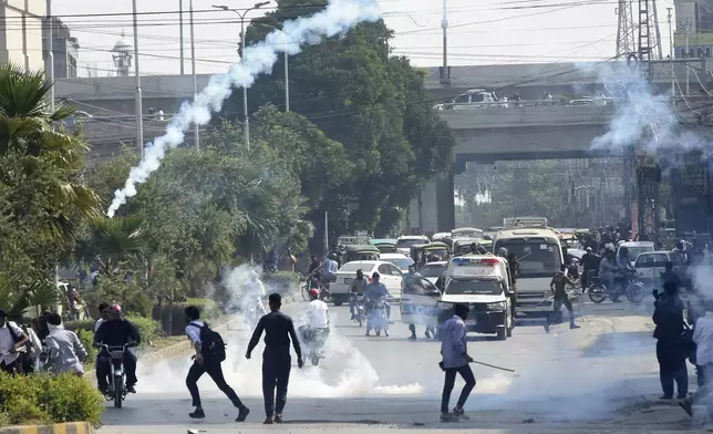 Police fire tear gas to disperse students protesting over an alleged on-campus rape in Punjab, in Rawalpindi, Pakistan, Thursday, Oct. 17, 2024. (AP Photo/W.K. Yousafzai)