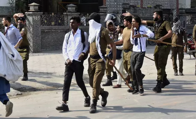 Police officers detain students following a students protest over an alleged on-campus rape in Punjab, in Rawalpindi, Pakistan, Thursday, Oct. 17, 2024. (AP Photo/W.K. Yousafzai)