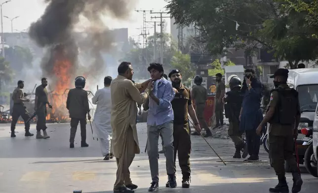 A plainclothes police officer detains a demonstrator during a students' protest over an alleged on-campus rape in Punjab, in Rawalpindi, Pakistan, Thursday, Oct. 17, 2024. (AP Photo/W.K. Yousafzai)