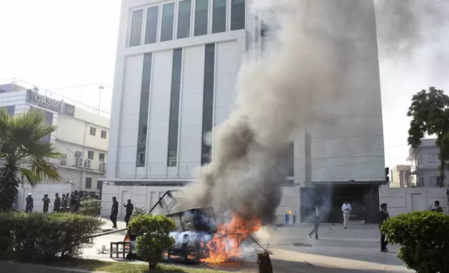 Smoke erupts from burning furniture and other materials set on fire by angry students protesting over an alleged on-campus rape in Punjab, in Rawalpindi, Pakistan, Thursday, Oct. 17, 2024. (AP Photo/W.K. Yousafzai)