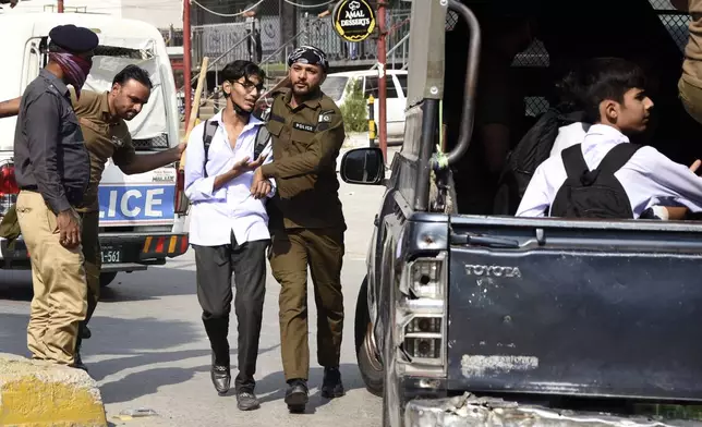 Police officers detain students following a students protest over an alleged on-campus rape in Punjab, in Rawalpindi, Pakistan, Thursday, Oct. 17, 2024. (AP Photo/W.K. Yousafzai)