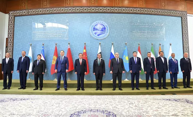 In this photo released by the Press Information Department, Pakistan's Prime Minister Shehbaz Sharif, center, China's Premier Li Qiang, fifth left, Belarus Prime Minister Roman Golovchenko, fourth left, Russian Prime Minister Mikhail Mishustin, sixth right, Kazakhstan's Prime Minister Olzhas Bektenov, fifth right, Tajikistan's Prime Minister Kokhir Rasulzoda, fourth right, and other leaders pose for group photo at the opening session of Shanghai Cooperation Organization (SCO) meeting in Islamabad, Pakistan, Wednesday, Oct. 16, 2024. (Press Information Department via AP)