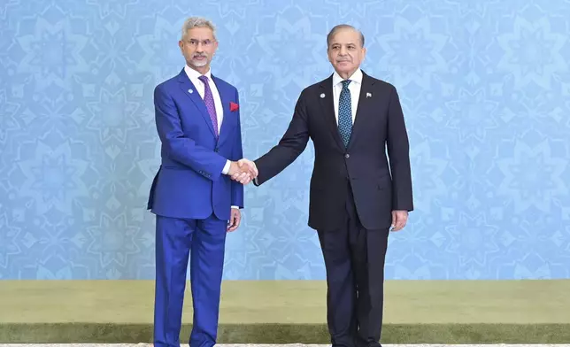 In this photo released by the Press Information Department, India's Minister for External Affairs Subrahmanyam Jaishankar, left, shakes hand with Pakistani Prime Minister Shehbaz Sharif as he arrives to attend Shanghai Cooperation Organization (SCO) meeting, in Islamabad, Pakistan, Wednesday, Oct. 16, 2024. (Press Information Department via AP)