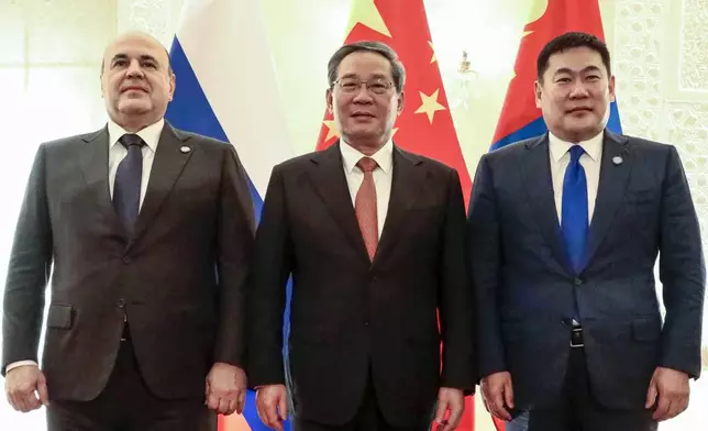 Russian Prime Minister Mikhail Mishustin, left, Chinese Premier Li Qiang, center, and Mongolian Prime Minister Luvsannamsrain Oyun-Erdene pose for a photo on the sidelines of the Shanghai Cooperation Organization (SCO) Council of Heads of Governments Summit in Islamabad, Pakistan, Wednesday, Oct. 16, 2024. (Roman Naumov, Sputnik, Government Pool Photo via AP)