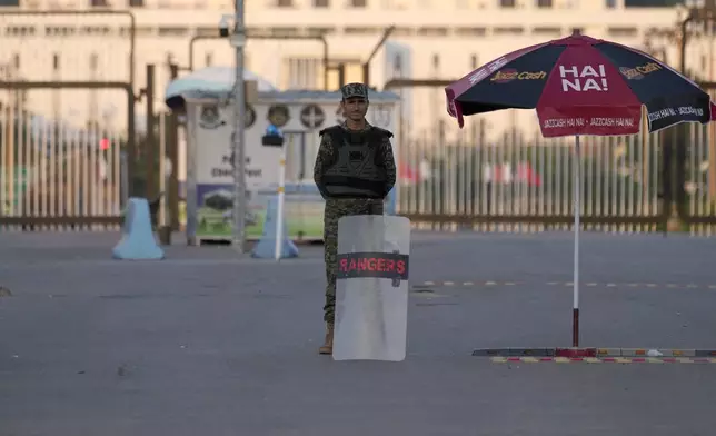 A paramilitary soldier stands guard at a barricaded road leading to Presidency, in background, and to the venue of the upcoming Shanghai Cooperation Organization (SCO) summit in Islamabad, Pakistan, Sunday, Oct. 13, 2024. (AP Photo/Anjum Naveed)